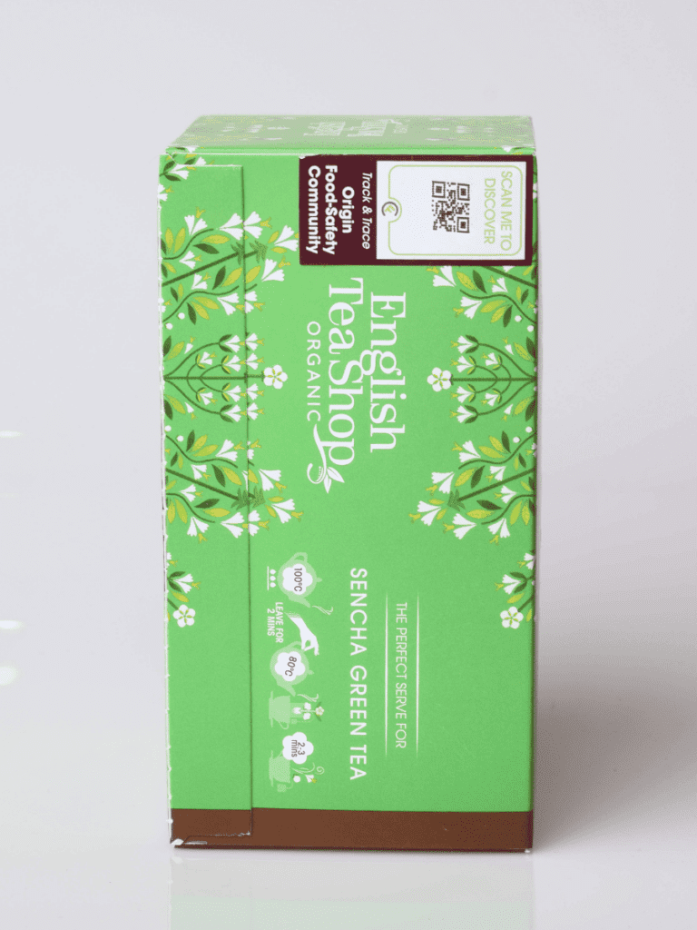 Grøn æske med Sencha Green Tea fra English Tea Shop, floral grafik, økologisk mærkning og tilberedningsikoner.